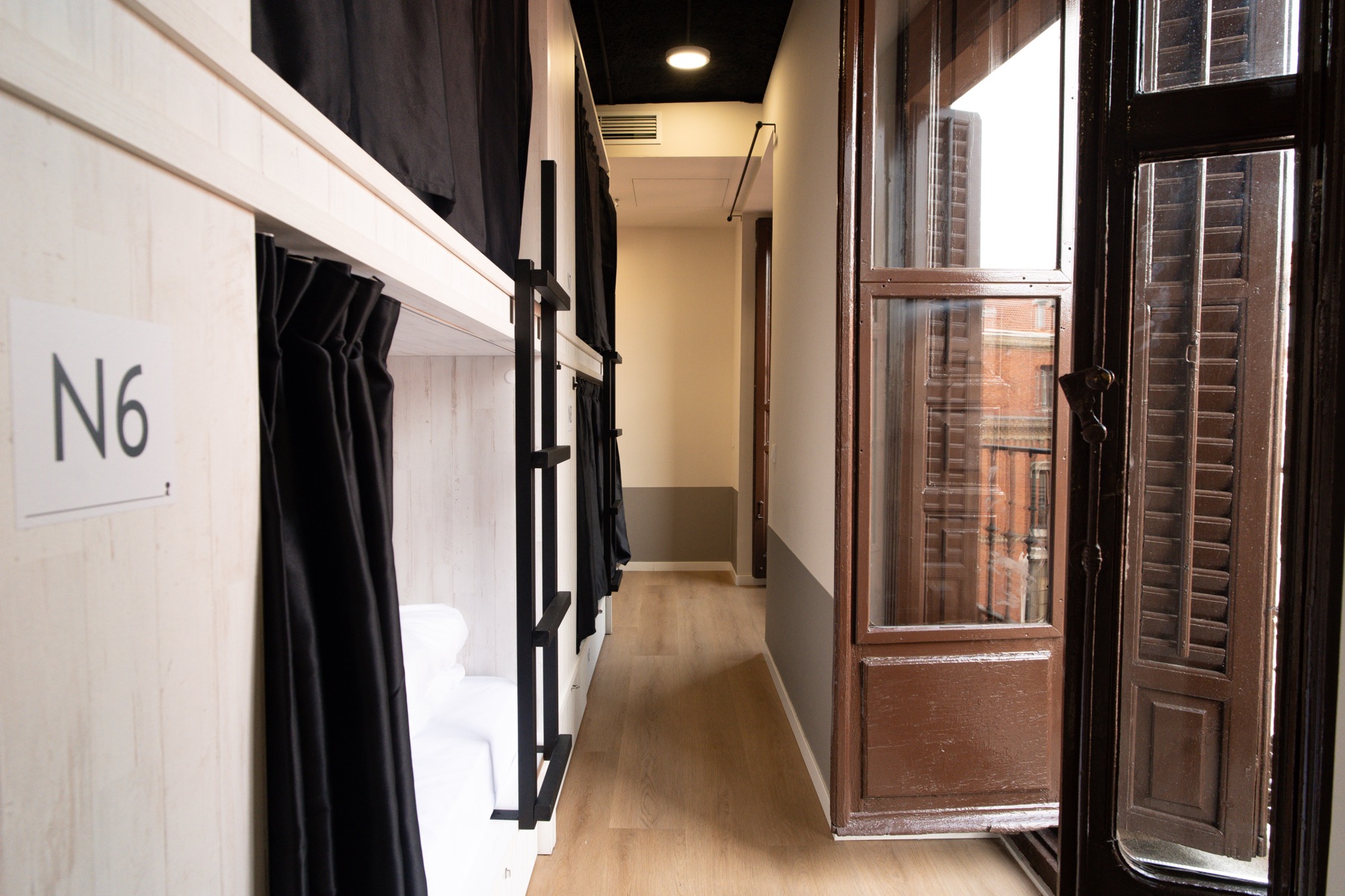 Shared room with bunk beds and windows onto the courtyard